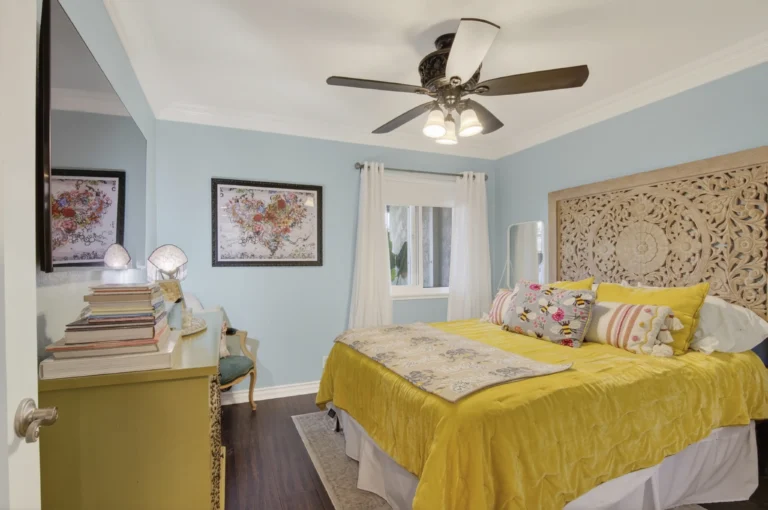 Bedroom staged with artwork and coordinated accent pillows