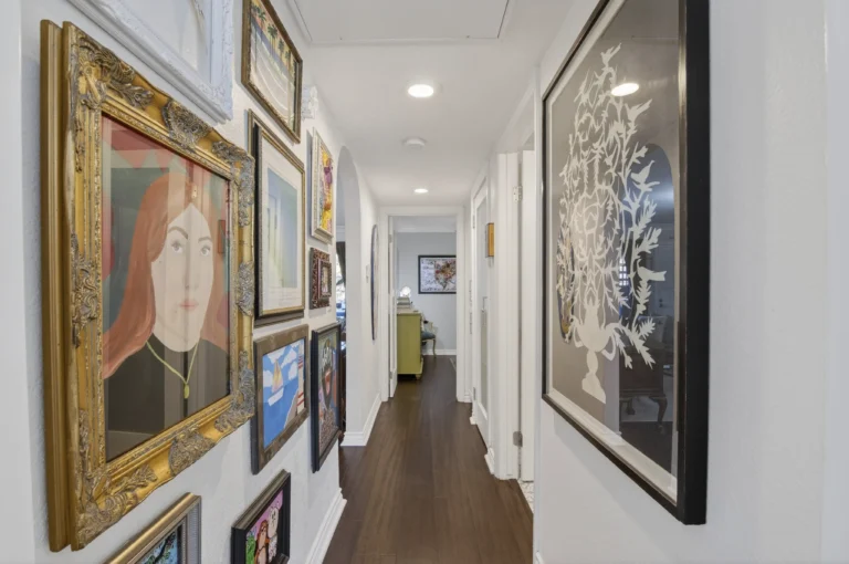 Hallway with various art works on the walls