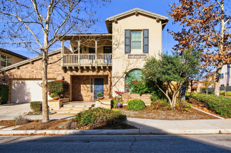 Front exterior showing entry door, garage, driveway and lawn