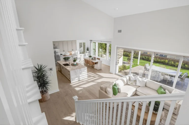 Upstairs landing with railing overlooking two story living room