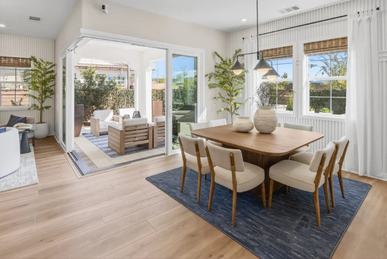 Dining area positioned next to sliding doors to the outside
