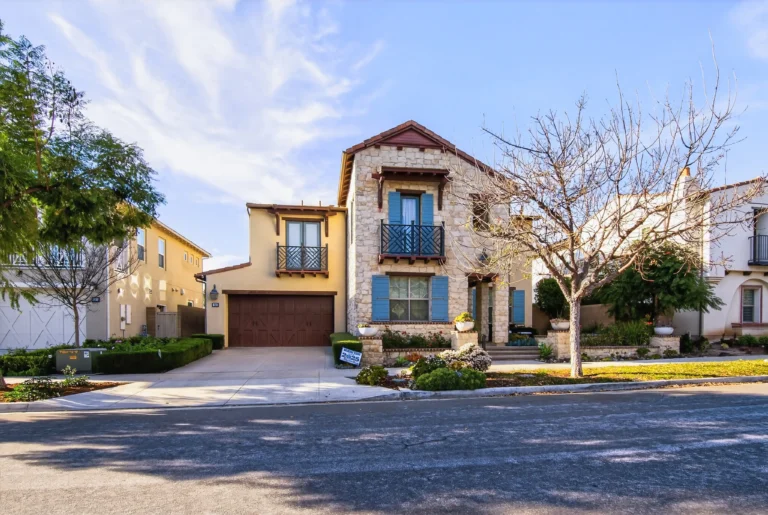 Exterior showcasing mix of stone accents, stucco and modern windows