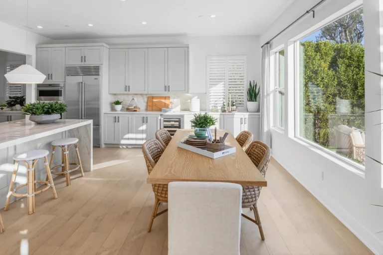 Dining area positioned near kitchen breakfast bar and island