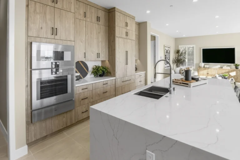 Open concept kitchen flowing into dining and living spaces