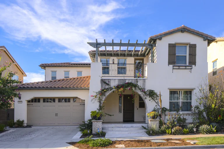Coastal style exterior with light siding, balcony
