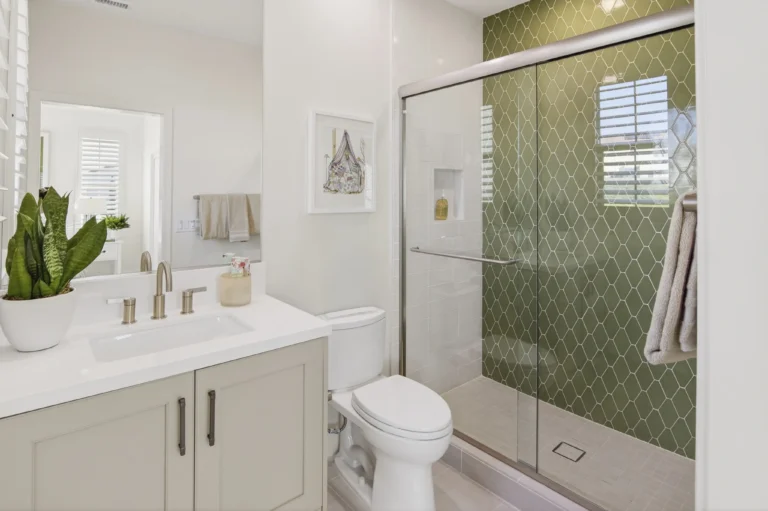 Bright bathroom with window, white tile and clean finishes