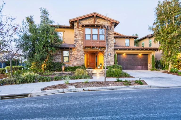 Modern home exterior featuring clean lines, large windows and stucco with brick accents
